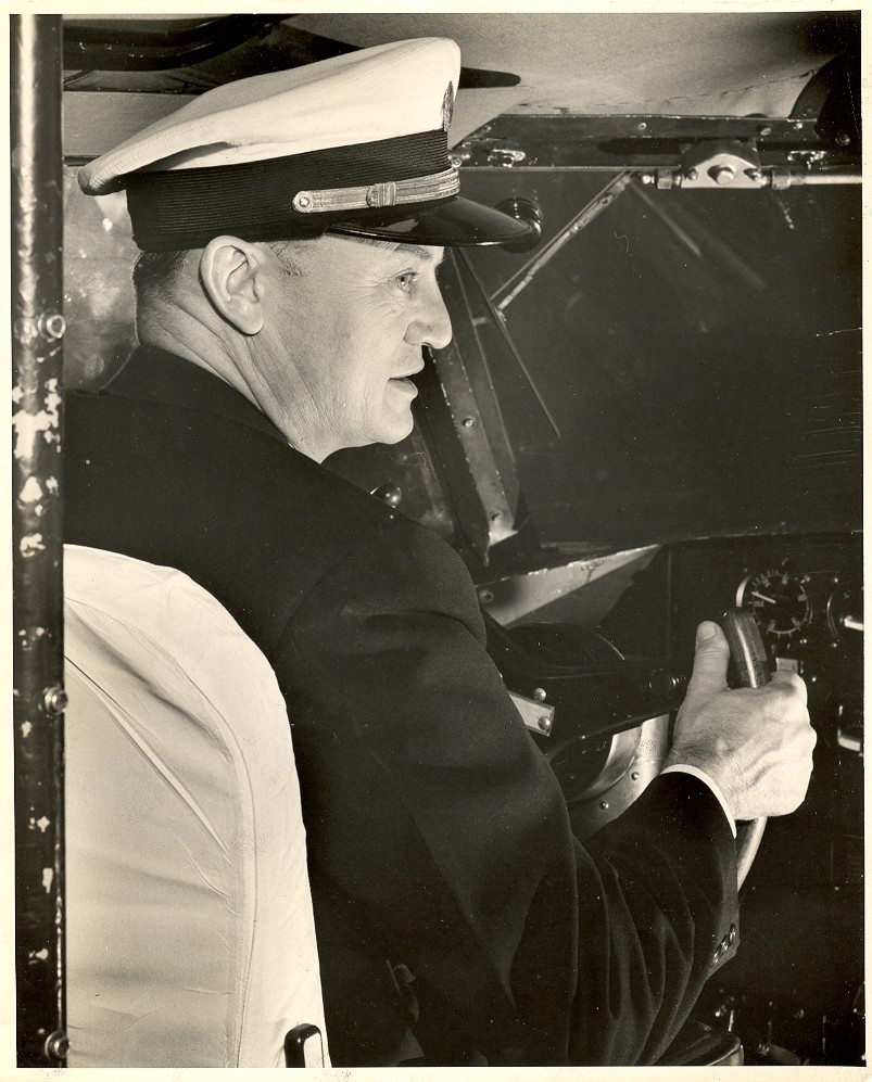 1950s Pan Am pilot at cockpit controls